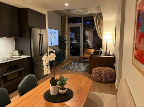 a kitchen and a living room with a table in a kitchen at Rainey St -Luxury 1BR - Top Amenities -RT Pool -17 in Austin