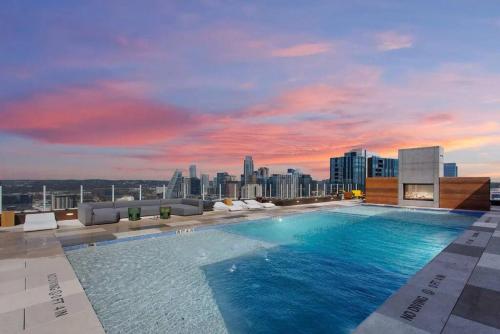 a large swimming pool on the roof of a building at Rainey St -Luxury 1BR - Top Amenities -RT Pool -17 in Austin