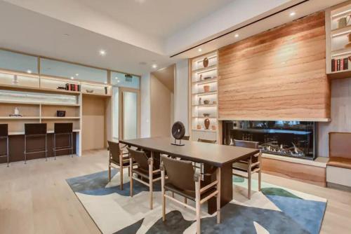 a dining room with a table and chairs and a fireplace at Rainey St -Luxury 1BR - Top Amenities -RT Pool -17 in Austin
