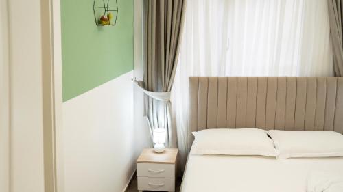 a bedroom with a white bed and a window at Hotel Luris in Golem