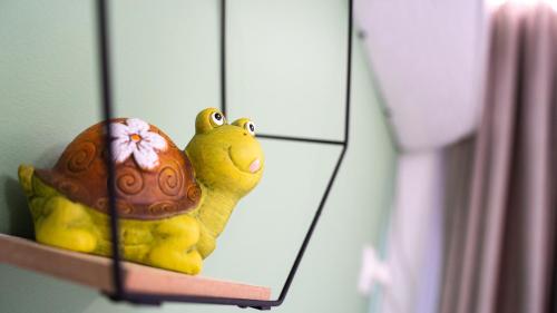 a stuffed animal sitting on a shelf in front of a mirror at Hotel Luris in Golem