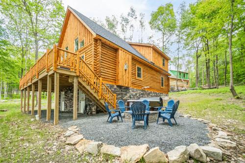 a log cabin with a table and chairs in front of it at Almost Eden in McHenry