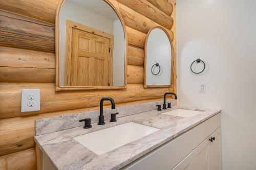 a bathroom with two sinks and a mirror at Almost Eden in McHenry