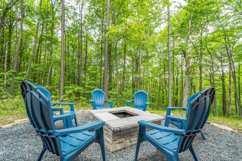 a group of chairs around a fire pit in the woods at Almost Eden in McHenry