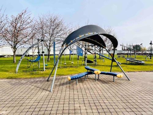 a playground with a slide in a park at Lola’s Caravan. Your home away from home. in Parkeston