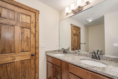 a bathroom with two sinks and a large mirror at Happy Ours in McHenry