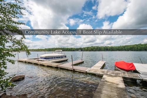 a dock with a boat on a body of water at Knotty Pines in Oakland
