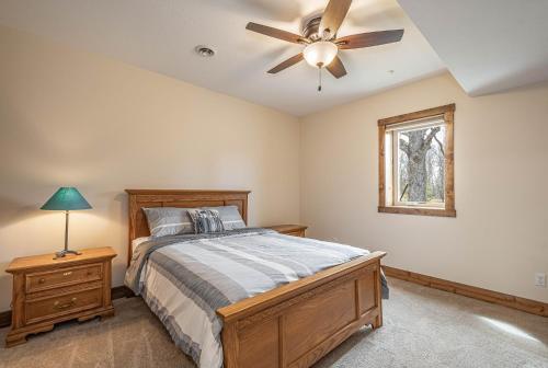 a bedroom with a bed and a ceiling fan at Happy Ours in McHenry