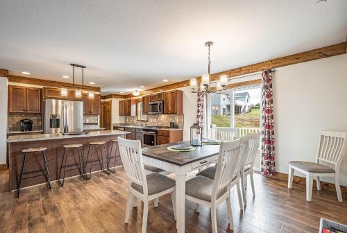 a kitchen with a dining room table and chairs at Happy Ours in McHenry