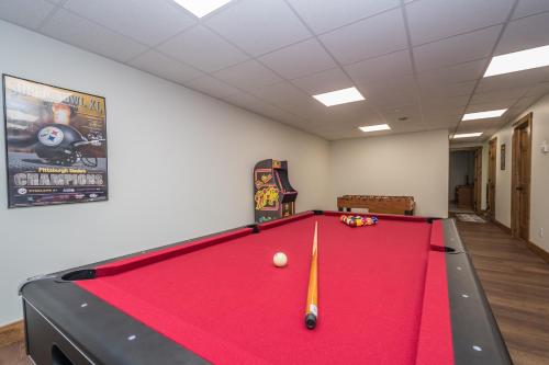 a pool table in a room with a red cloth at Happy Ours in McHenry