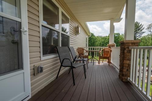 a porch with chairs and a table on a house at Happy Ours in McHenry