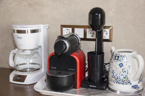 a counter with a coffee maker and cups on it at Kika Residences in Agios Nikolaos