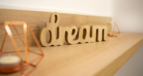 a wooden sign that says open on a table at Hotel Luris in Golem