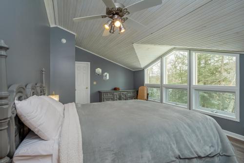 a bedroom with a bed with a ceiling fan at Lake Life HQ in McHenry