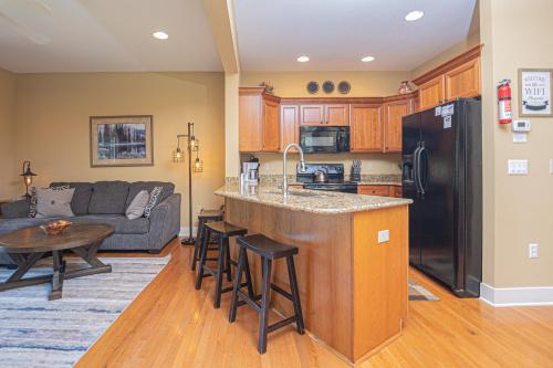 a kitchen and living room with a couch and a kitchen island at Live a Little in McHenry