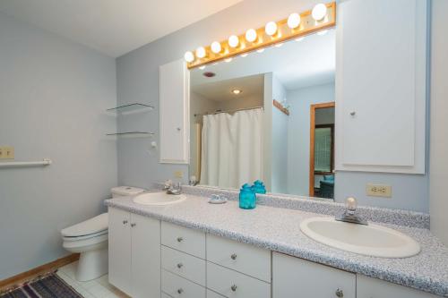 a bathroom with two sinks and a large mirror at Just Around the Dilly in Swanton