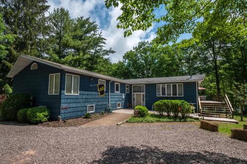a blue house with a driveway at Just Around the Dilly in Swanton