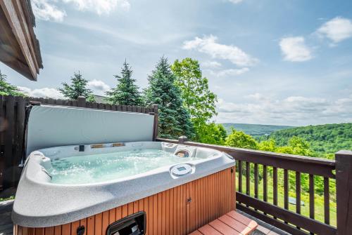 a jacuzzi tub on the deck of a house at Happyplace Hideaway in McHenry