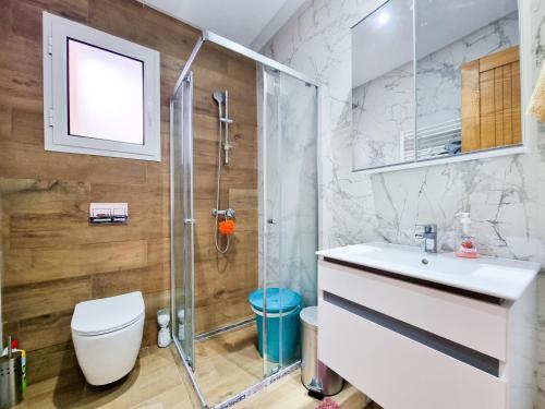 a bathroom with a shower and a toilet and a sink at Appartement Salon et une chambre - TUN104 in Nabeul