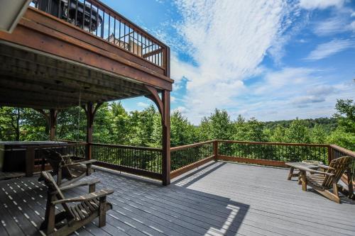a wooden deck with benches and a balcony at Hawk Mountain in McHenry