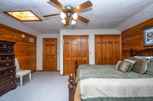 a bedroom with a bed and a ceiling fan at Forever Young in McHenry