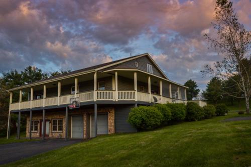 a large house with a wrap around porch at Forever Young in McHenry