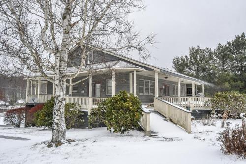 a house with a porch in the snow at Forever Young in McHenry