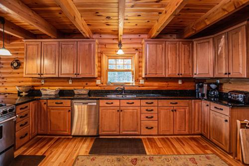 a large kitchen with wooden cabinets and a window at Altitude Adjustment in McHenry