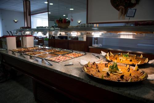 a buffet line with many different types of pizzas at Hotel Internacional in Calella
