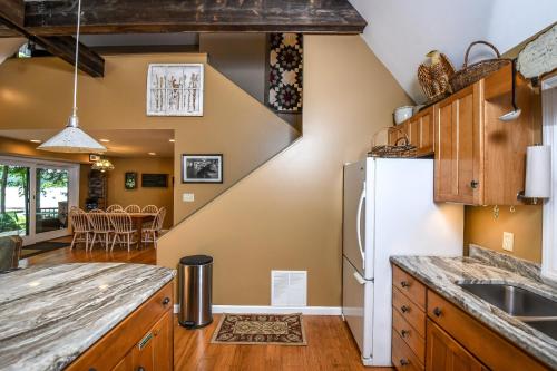 a kitchen with a staircase leading to a dining room at Glen Clova in Swanton