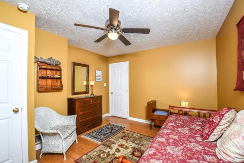 a bedroom with a bed and a ceiling fan at Glen Clova in Swanton