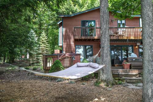 a hammock in front of a log house at Glen Clova in Swanton