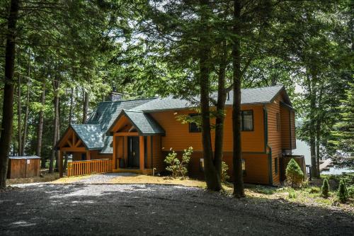 a cabin in the woods with a lot of trees at Glen Clova in Swanton