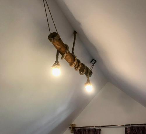 a chandelier hanging from the ceiling in a room at Magic Garden Villa in Vama Veche