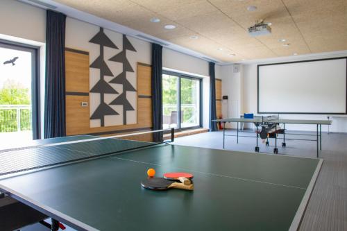 a ping pong room with a ping pong table at Amenity Hotel & Resort Orlické hory in Deštné v Orlických horách
