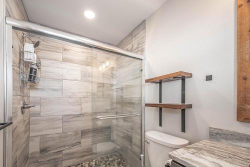 a bathroom with a shower and a toilet at Hearthstone in McHenry