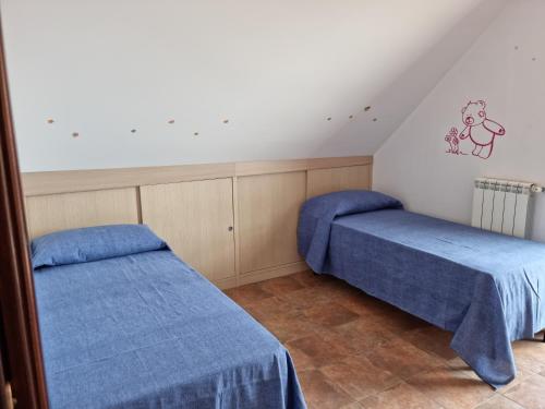 - 2 lits dans une chambre avec des draps bleus dans l'établissement Casa vacanza Amanda, à Nicotera Marina