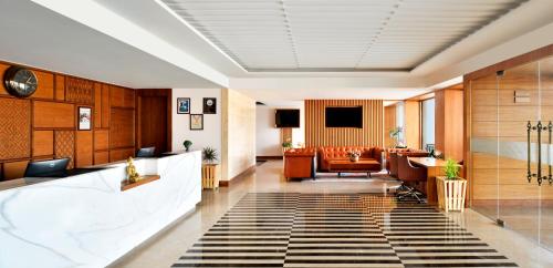 a lobby of a hotel with a waiting room at Golden Tulip Jalandhar in Jalandhar