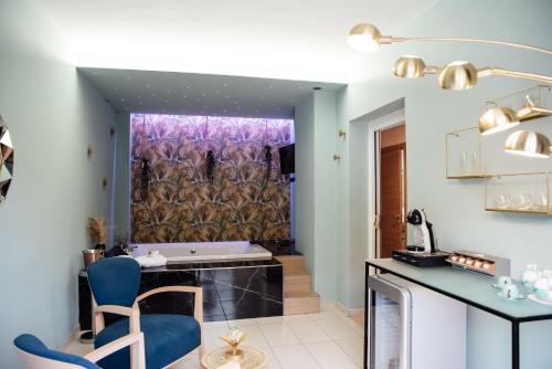 a bathroom with a tub and a table and a chair at Hotel St. Giorgio in Castel San Giorgio