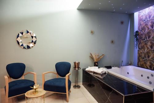 a bathroom with two chairs and a tub at Hotel St. Giorgio in Castel San Giorgio