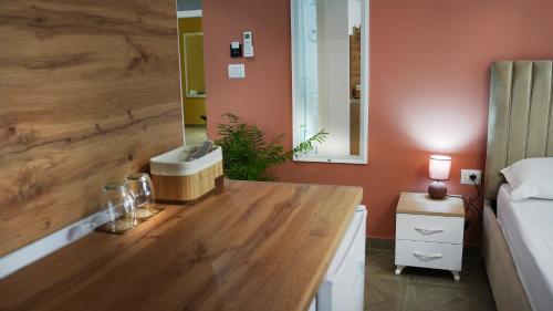 a bathroom with a counter with a sink and a bed at Hotel Luris in Golem