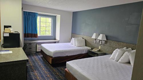 a hotel room with two beds and a television at MJ INN and SUITES in Marienville