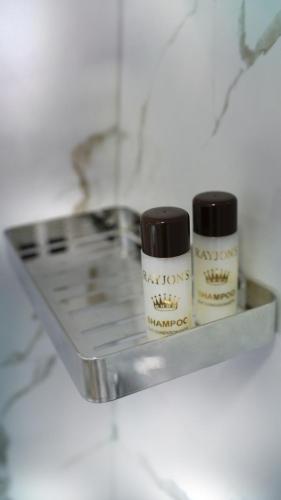 two bottles ofagents sitting on a shelf on a counter at Hotel Luris in Golem