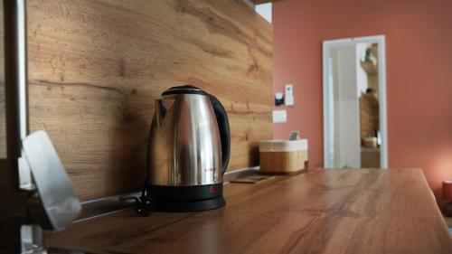 a coffee maker sitting on top of a wooden table at Hotel Luris in Golem