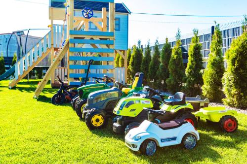 a row of toy vehicles parked in the grass at KASHUBIAN Resort in Władysławowo