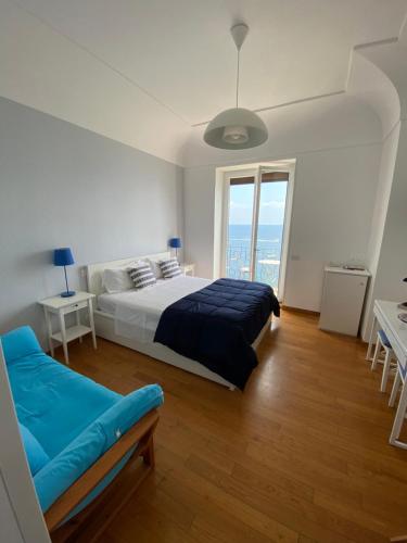 a bedroom with a bed and a large window at Capri Inn in Capri