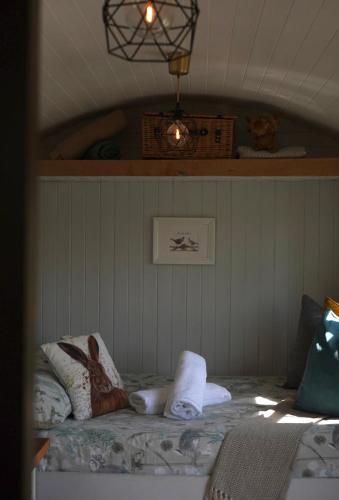 a bedroom with a bed with towels on it at Four Acres Farm in Donaghadee