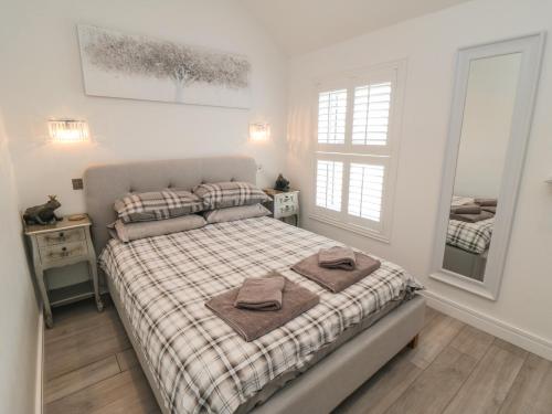 a bedroom with a bed with two towels on it at True North in Scarborough