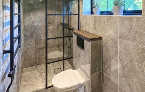 a bathroom with a toilet and a shower at Cozy Home In Äspered With Sauna in Dalsjöfors