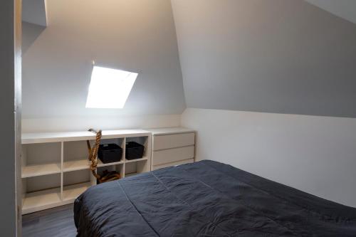 a bedroom with a bed and a skylight at Sky View in Tilburg
